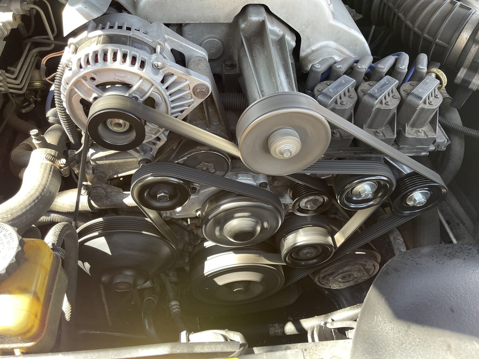 Reassembled drive belts and pulleys on the Holden VX Supercharged engine