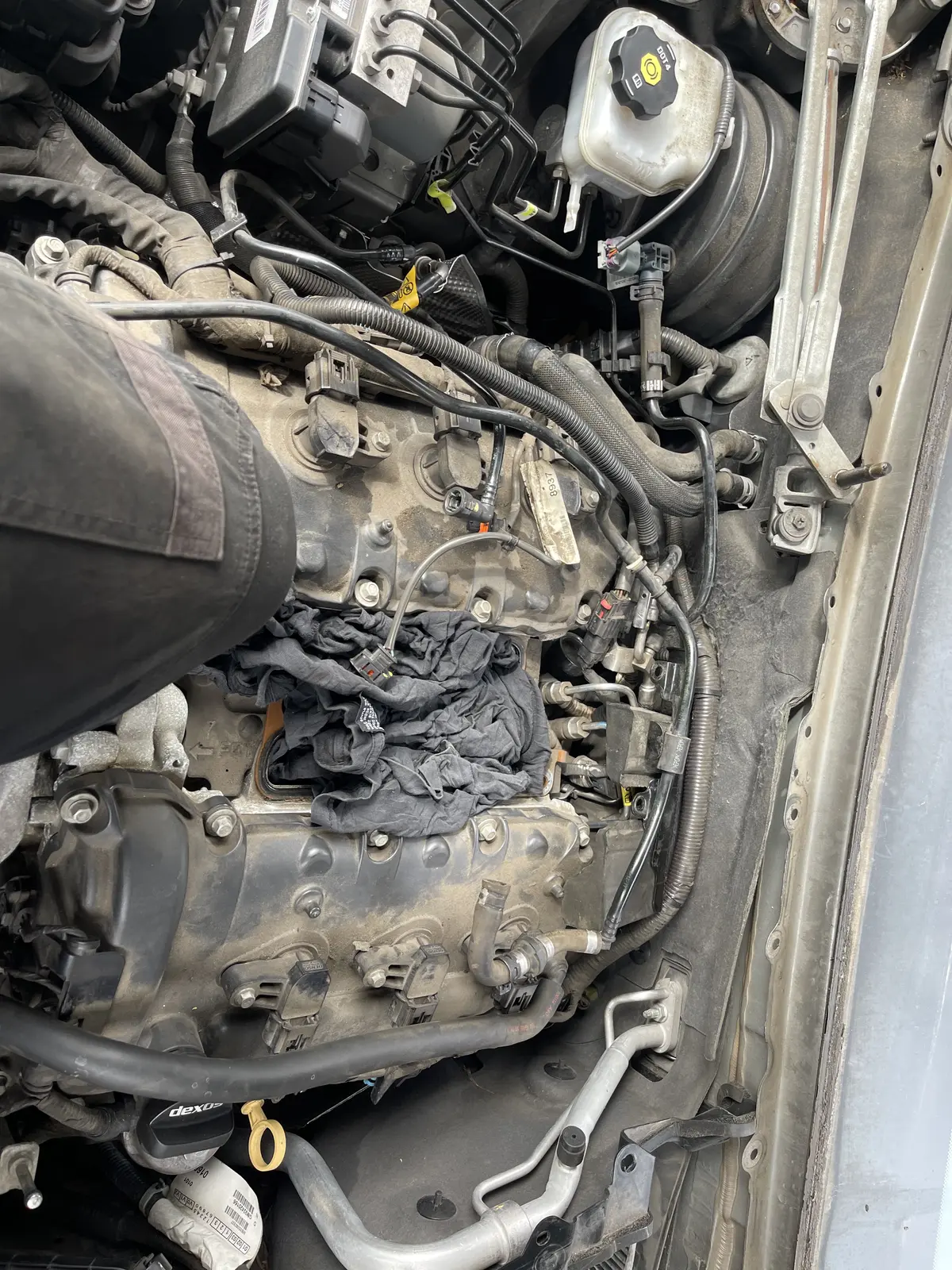 Engine bay with intake openings covered during the on-site fuel-pump repair
