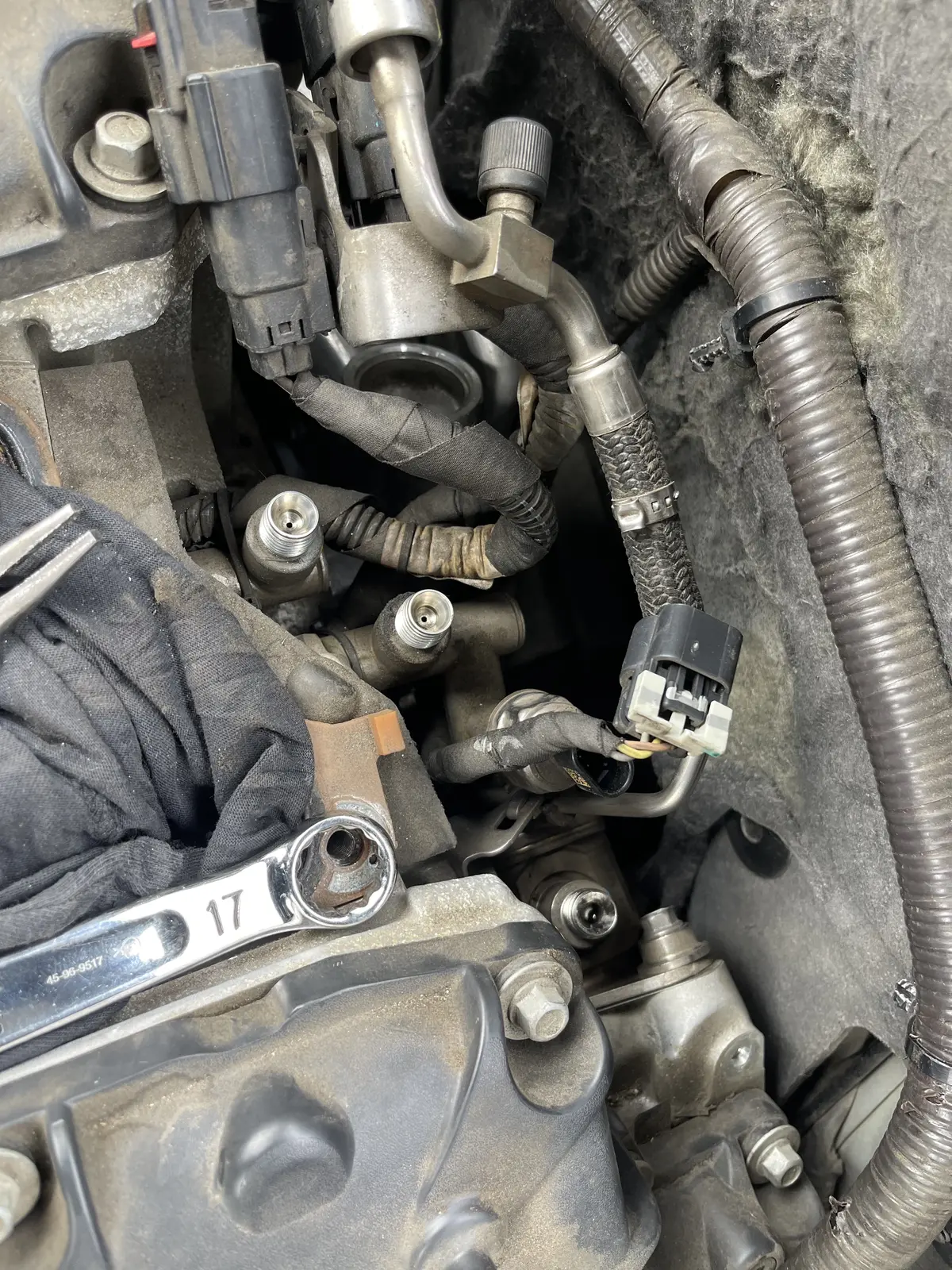 Close view of disconnected fuel-pump fittings and surrounding wiring