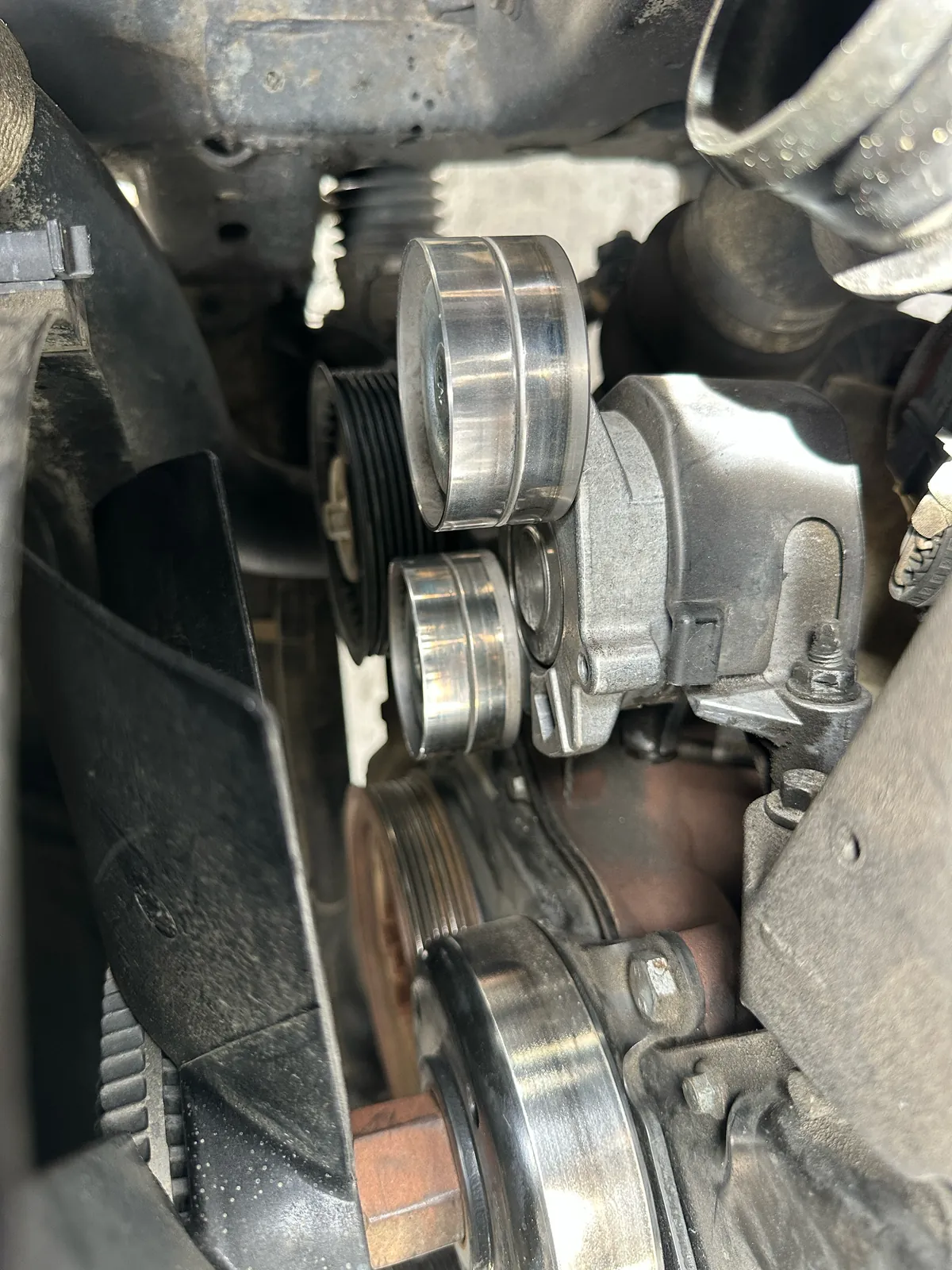 Replacement drive belt tensioner in the Ford Ranger engine bay during repair