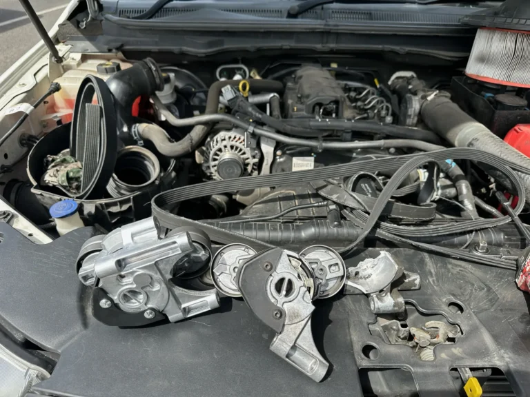 Old broken and replacement Ford Ranger drive belt tensioners side by side
